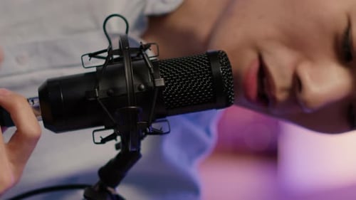 Close Up of Young Man Attaching Cord to Microphone