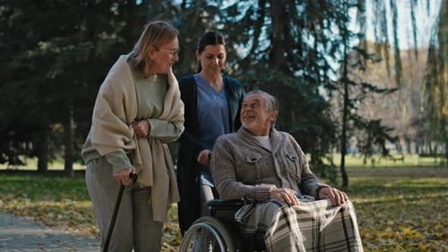 Female nurse walking with senior patients in park. Shot with RED helium camera in 8K
