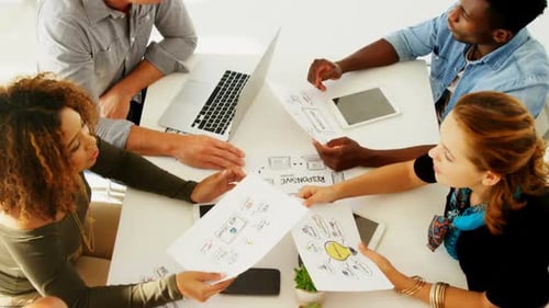 Team of executives interacting with each other while working in the office