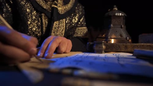 Person Writing with Quill Pen by Candlelight