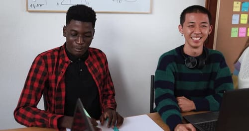 Multiracial students studying together inside class room- School concept