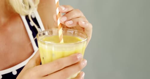 Woman Drinks Smoothie with Straw, Close Up