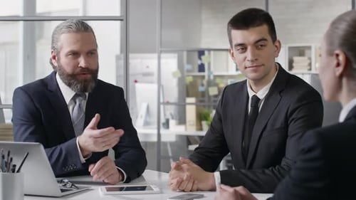 Three Business People Meeting in Office Workplace