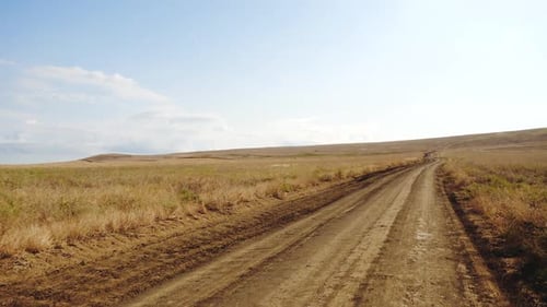 Moving Front Shot From the Top of Car Driving on Road Outside the City on a Bright Sunny Spring Day