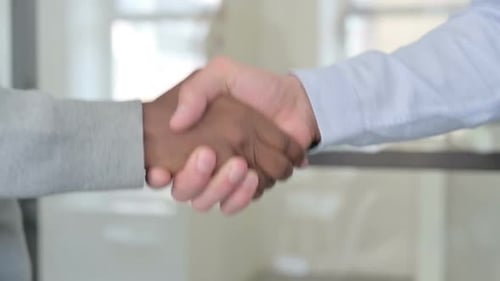 Close Up of Mixed Race Businessmen Shaking Hands in Slow Motion