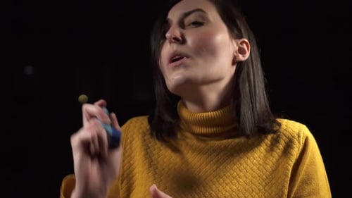 Woman having breathing issues using inhaler