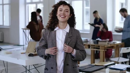 Young Woman Smiling in Modern Workplace