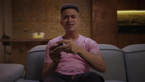 Excited Man Playing Video Game on Couch