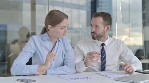 Business People Discussing the Documents on Office Desk