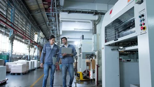 specialist worker engineer team control and operate printing package lable machine