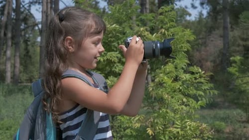 Girl Taking Pictures With Camera in Forest