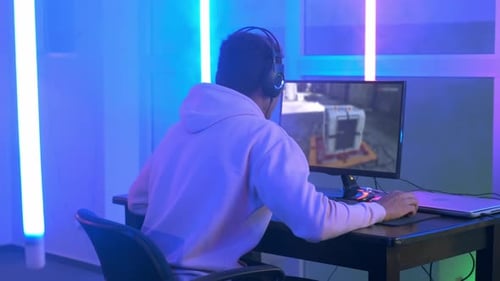 Back View of Young Gamer Winning Online Game