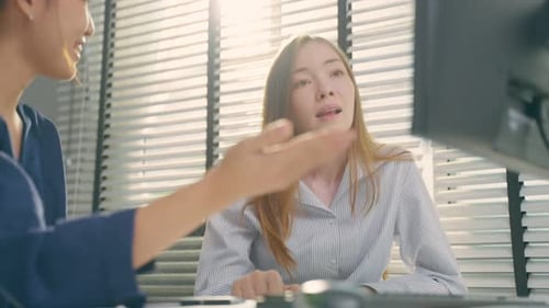 Young Asian business woman work with Caucasian woman manager in office.