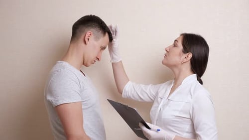Doctor Examines Young Man in Clinic