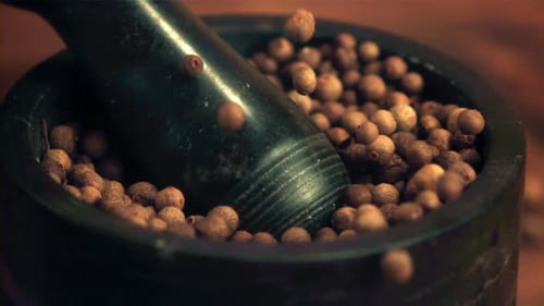 Allspice Berries Falling Into Mortar Close Up