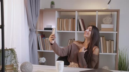 Young Woman Takes Selfie in Bright Home Office