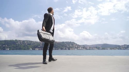 Businessman shouting for his success against the sea.
