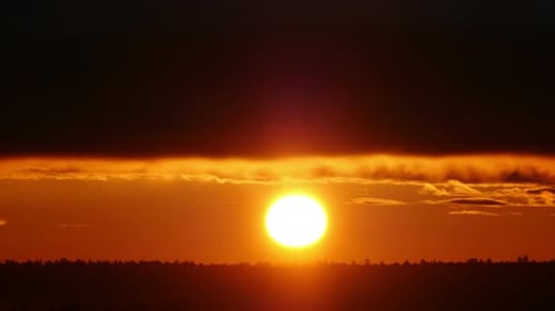 Red Sun Rises Over the Horizon Timelapse
