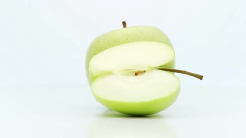 Green Apple with Slice on White