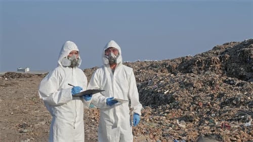 Scientist wearing protection suit and checking waste will be dumped in this area