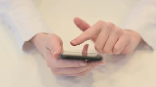 Close Up Female Hands Typing on Smartphone