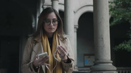 Young Woman Listening to Music in the City