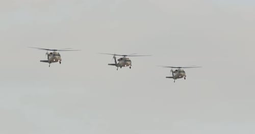 Three Helicopters Flying in Formation