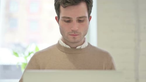Close Up of Man Working on Laptop