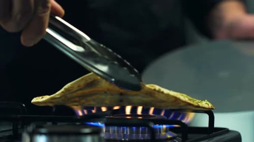 Flatbread with Green Sauce Cooking on Gas Stovetop