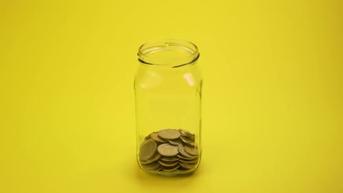 Coins Filling Glass Jar for Savings