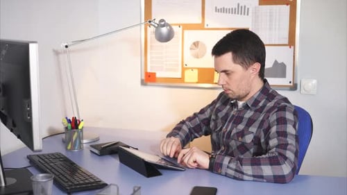 Office Worker Typing at Tablet and Thinking.