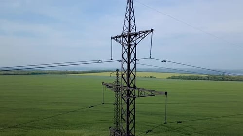 Aerial View of Transmission Tower in Green Field