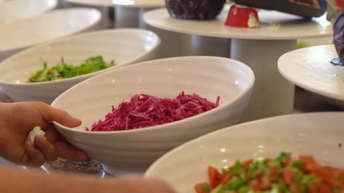 Hotel attendant, preparing breakfast buffet.