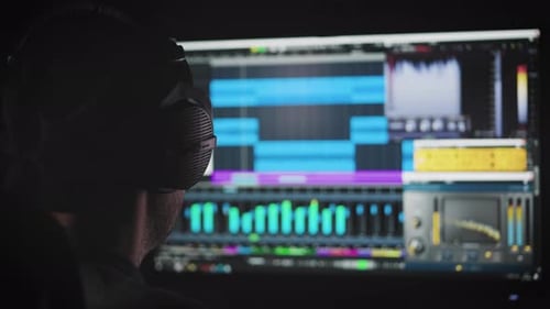 An Experienced Sound Engineer Mixes a Music Track in His Home Studio