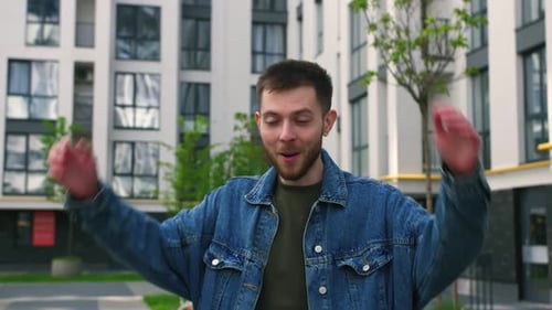 Excited Man Reacting to Good News Outside