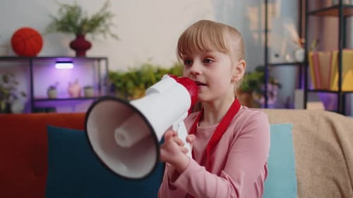 Child Girl Kid Standing on Sofa at Home Alone Loudly Shout in Megaphone Announces Discounts Sale