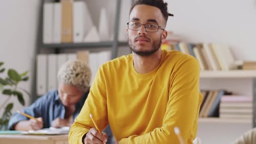 Young Adult Writes in Classroom Setting