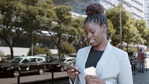 Businesswoman Using Cellphone in Urban Setting