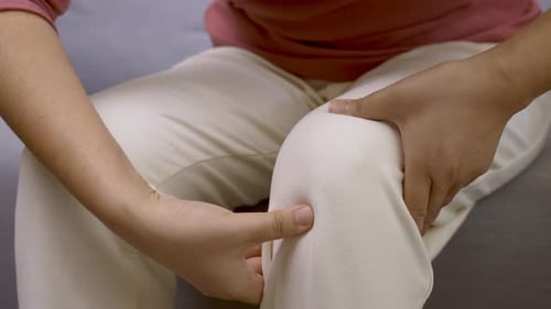 Close Up of Woman Massaging Knee
