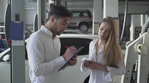 Pretty Female Manager Tells the Handsome Client How To Fill Out the Machine Repair Contract and