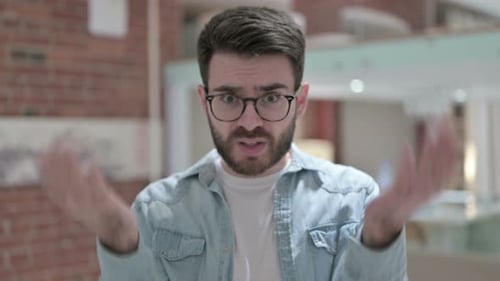 Frustrated Young Adult with Glasses and Beard
