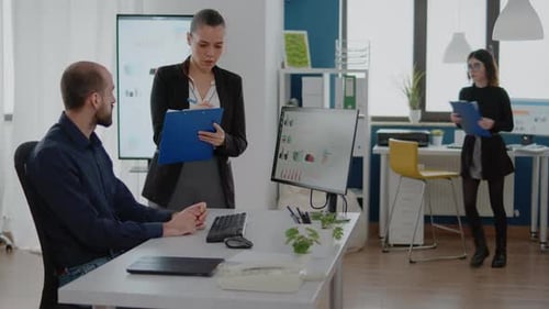 Business Colleagues Discussing Data in Modern Office