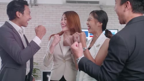 Successful Business Team Celebrates Victory in Office