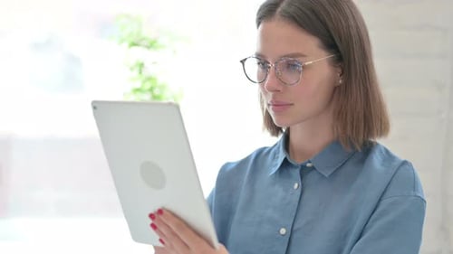 Woman Using Tablet Device in Bright Room