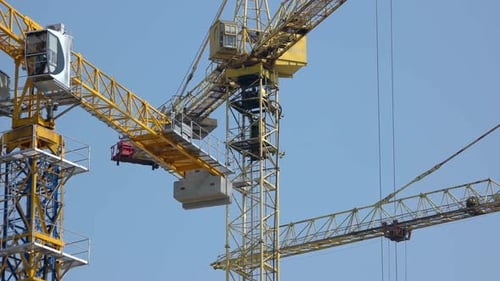 Rotating Steel Yellow Crane Over Blue Sky Background