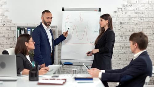 Business Meeting with Chart Presentation in Modern Office