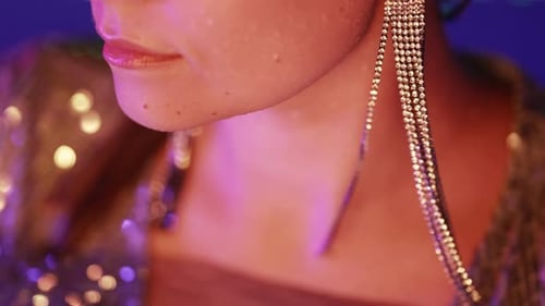 Gorgeous Woman with Long Crystal Earrings Posing in Pool at Night