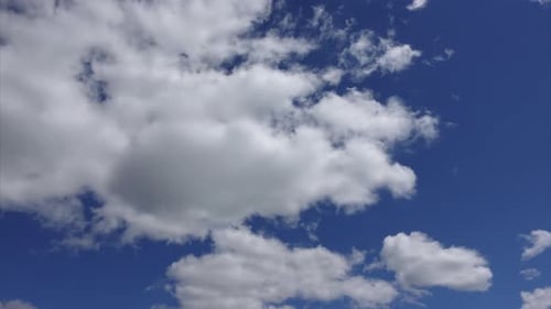 Fluffy Clouds Drifting Across a Blue Sky