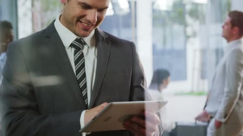 Man in Suit Using Tablet in Office