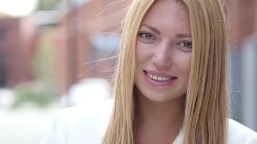 Smiling Woman Portrait with Blonde Hair in City